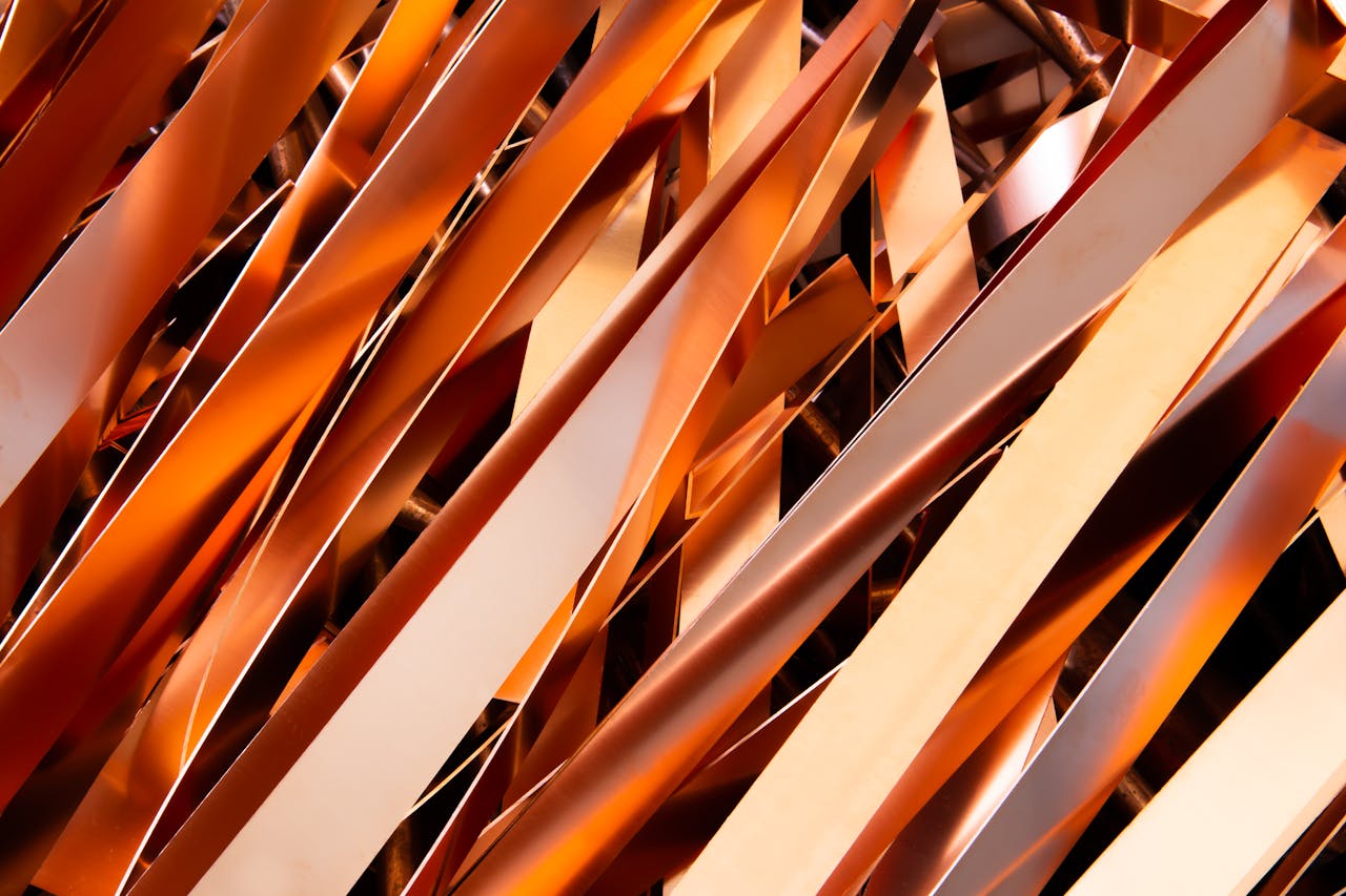 Close-up of intertwined metallic strips showcasing industrial recycling processes.